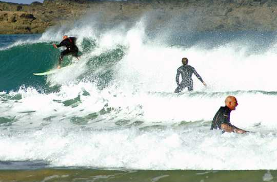 Surfers off the Cornish coast