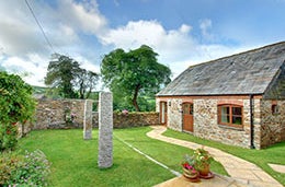 Cottage with garden and stone wall